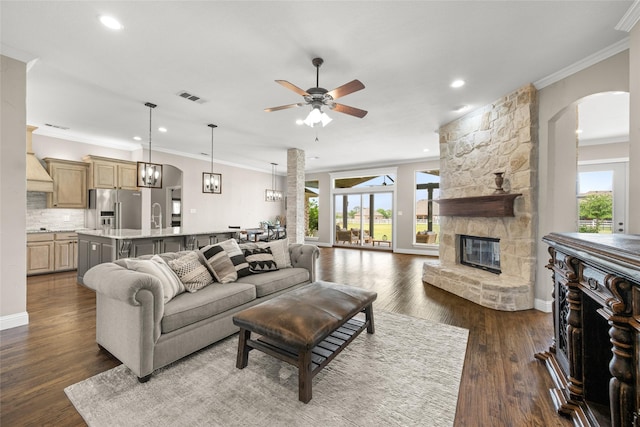 1009 Maida Vale, Haslet, TX 76052 - living area featuring arched walkways, ornamental molding, ceiling fan, a fireplace, and recessed lighting