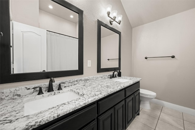 1009 Maida Vale, Haslet, TX 76052 - bathroom featuring double vanity, toilet, tile patterned flooring, vaulted ceiling, and baseboards