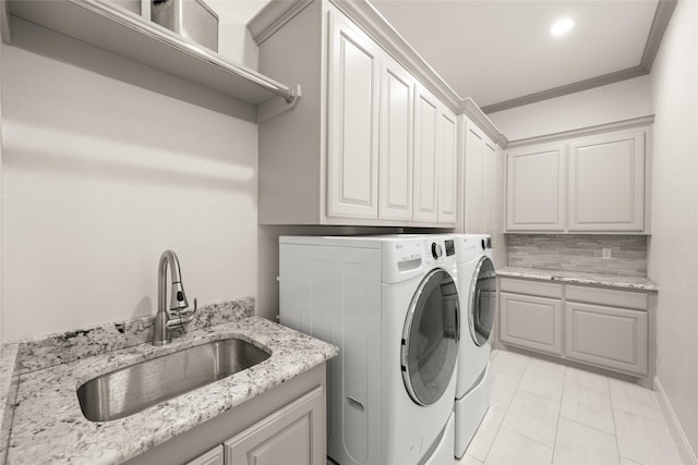 1009 Maida Vale, Haslet, TX 76052 - laundry room with cabinet space, washing machine and dryer, ornamental molding, and light tile patterned floors