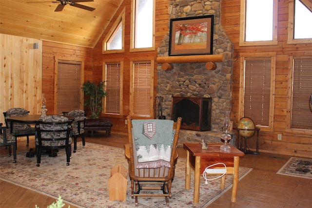 1147 Rs County Road 3503, Emory, TX 75440 - living area with wood walls, high vaulted ceiling, ceiling fan, wood-type flooring, and a stone fireplace