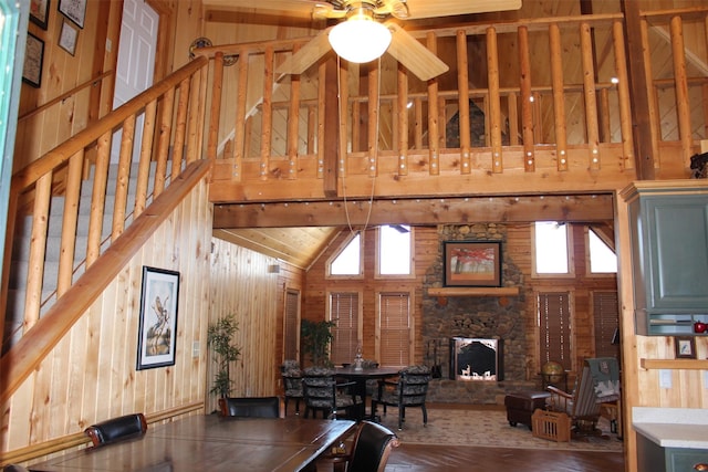 1147 Rs County Road 3503, Emory, TX 75440 - dining area featuring high vaulted ceiling, stairs, wood walls, wood finished floors, and a stone fireplace