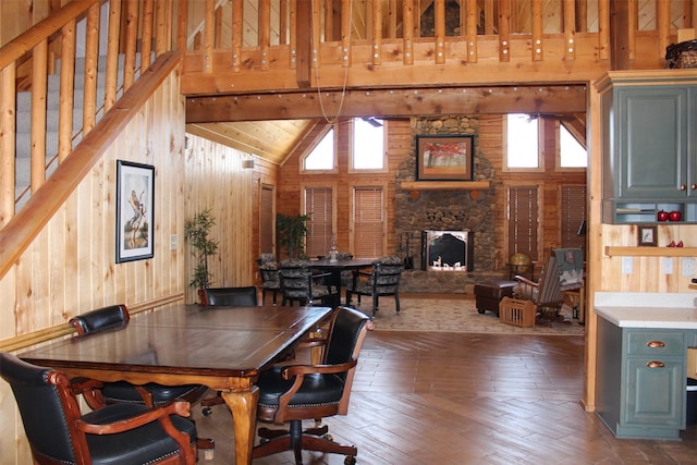1147 Rs County Road 3503, Emory, TX 75440 - dining room with wood walls, high vaulted ceiling, a fireplace, stairway, and hardwood / wood-style flooring