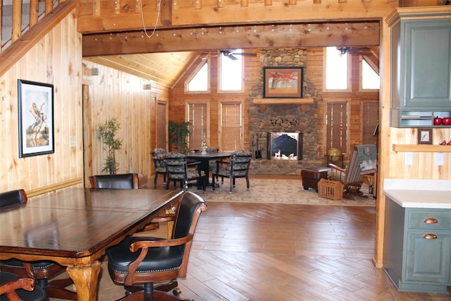 1147 Rs County Road 3503, Emory, TX 75440 - dining space with ceiling fan, lofted ceiling, wooden walls, hardwood / wood-style floors, and a fireplace