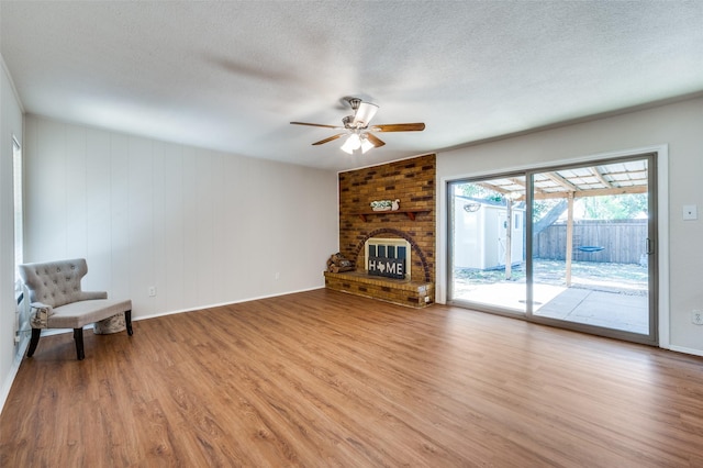 5072 Stanley Dr, The Colony, TX 75056 - unfurnished living room featuring a ceiling fan, light wood-style flooring, a textured ceiling, and baseboards