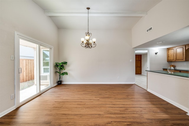 5072 Stanley Dr, The Colony, TX 75056 - unfurnished dining area featuring beamed ceiling, wood finished floors, a chandelier, baseboards, and a high ceiling