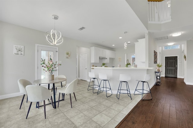 3925 Wisteria Ln, Haltom City, TX 76137 - dining area featuring a chandelier and light wood finished floors
