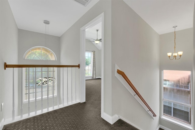 3925 Wisteria Ln, Haltom City, TX 76137 - corridor with an upstairs landing, a chandelier, dark carpet, and vaulted ceiling