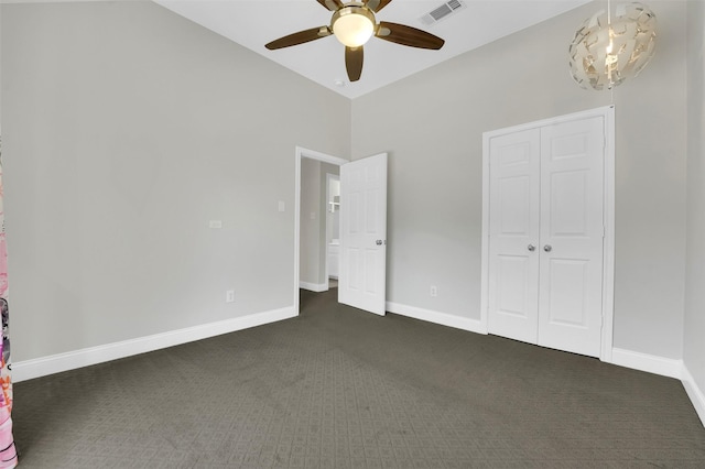 3925 Wisteria Ln, Haltom City, TX 76137 - unfurnished bedroom with dark colored carpet, ceiling fan, a closet, a chandelier, and high vaulted ceiling