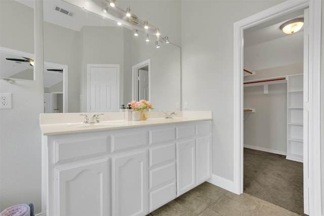 3925 Wisteria Ln, Haltom City, TX 76137 - full bath with double vanity, a walk in closet, tile patterned floors, and ceiling fan