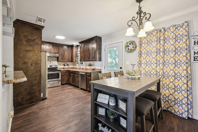 104 S Cedar St, Leonard, TX 75452 - kitchen with appliances with stainless steel finishes, under cabinet range hood, dark brown cabinetry, ornamental molding, and dark wood finished floors