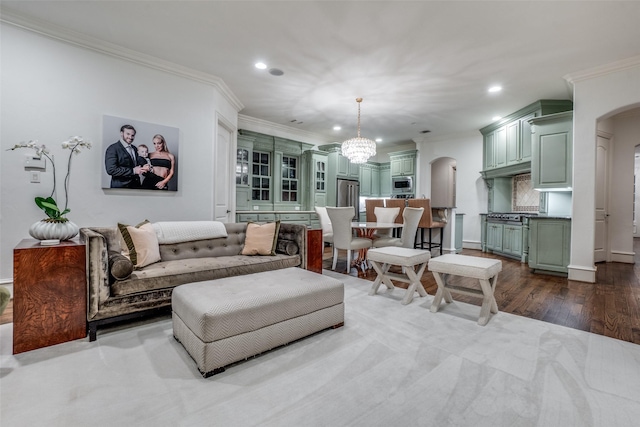 living room featuring arched walkways, recessed lighting, crown molding, a chandelier, and dark wood finished floors