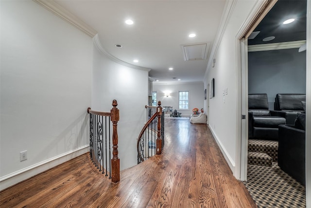 hallway featuring attic access, an upstairs landing, crown molding, wood finished floors, and recessed lighting