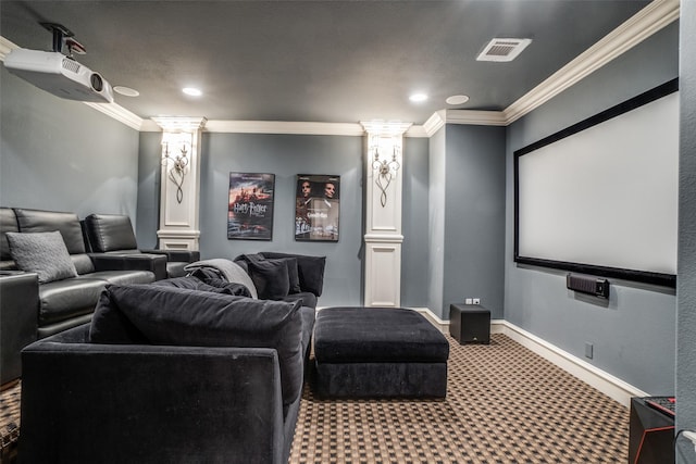 carpeted cinema room featuring ornate columns, crown molding, recessed lighting, and baseboards