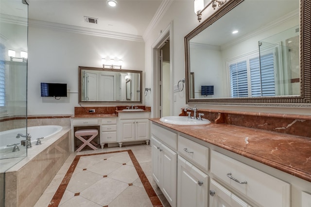 full bath with ornamental molding, a garden tub, two vanities, and recessed lighting