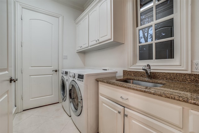 washroom with washing machine and clothes dryer, cabinet space, crown molding, and light tile patterned floors