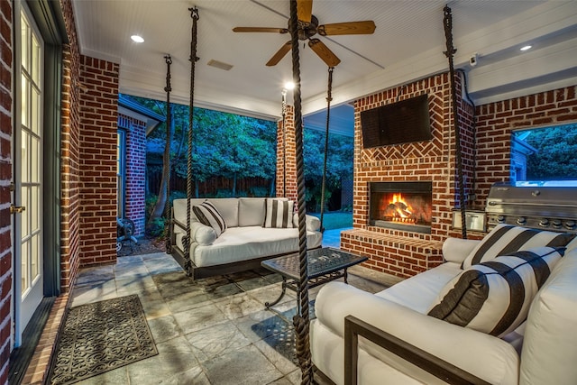 view of patio with an outdoor living space with a fireplace, fence, grilling area, and ceiling fan