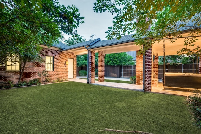 view of yard featuring a patio and a hot tub