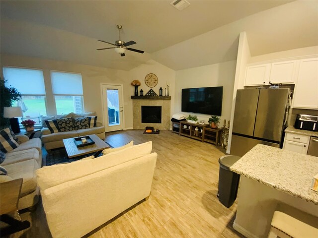 120 Black Alder Dr, Fort Worth, TX 76131 - living area with vaulted ceiling, a ceiling fan, light wood-type flooring, and a fireplace