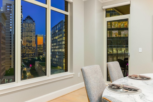 2525 N Pearl St Unit 1203, Dallas, TX 75201 - dining space featuring a view of city, baseboards, and wood finished floors