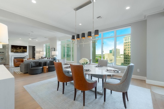 2525 N Pearl St Unit 1203, Dallas, TX 75201 - dining space featuring healthy amount of natural light, crown molding, light wood-type flooring, recessed lighting, and ceiling fan