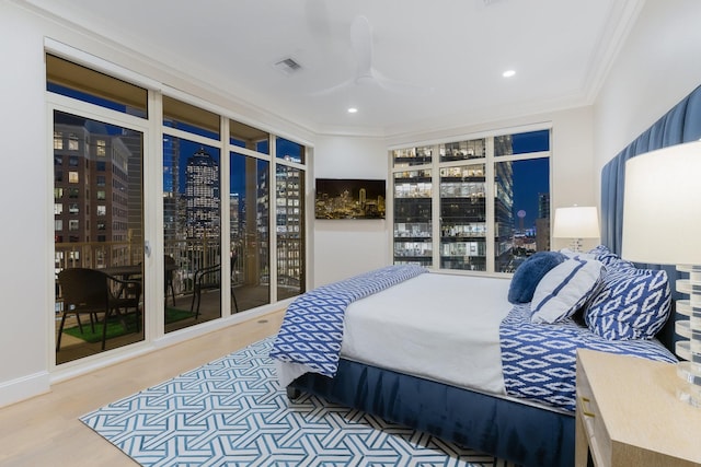 2525 N Pearl St Unit 1203, Dallas, TX 75201 - bedroom featuring crown molding, wood finished floors, recessed lighting, a city view, and ceiling fan