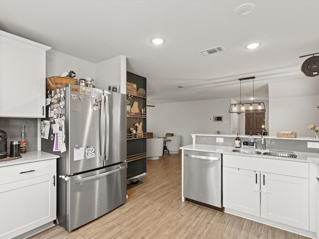 1359 Panorama Dr, Forney, TX 75126 - kitchen featuring stainless steel appliances, a sink, light countertops, white cabinets, and light wood-type flooring