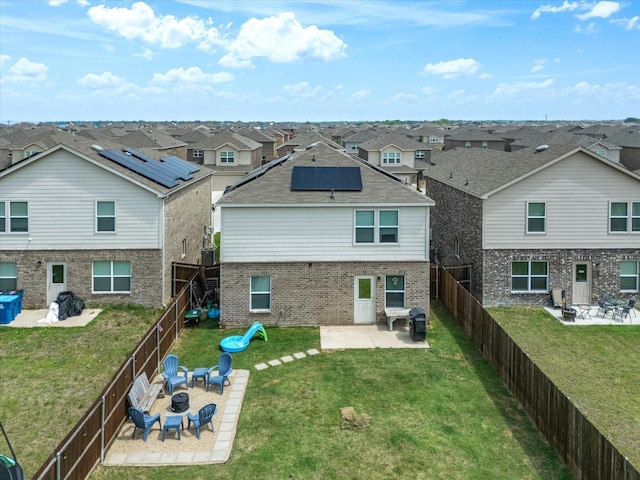 1359 Panorama Dr, Forney, TX 75126 - back of property with a fire pit, a residential view, a patio area, brick siding, and solar panels