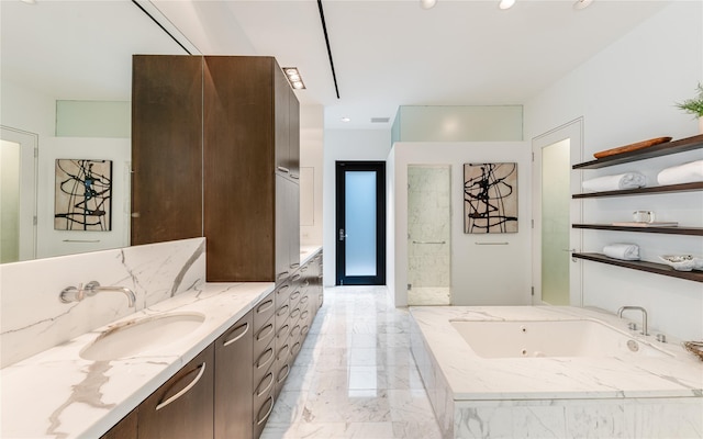 full bathroom featuring vanity, a tub with jets, and marble tiled floors