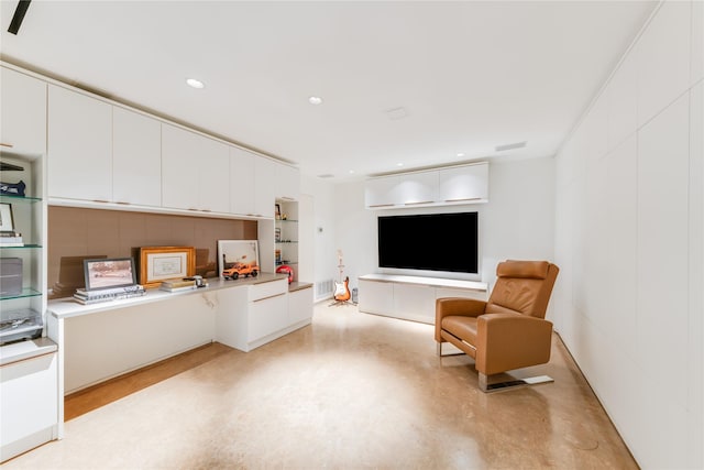 living room featuring concrete flooring and recessed lighting