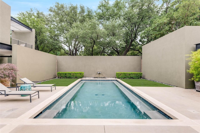 view of pool featuring fence and a patio area