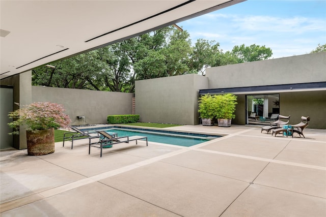 view of pool with a patio area and fence