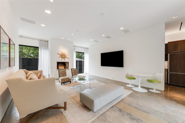 living room featuring concrete flooring and recessed lighting