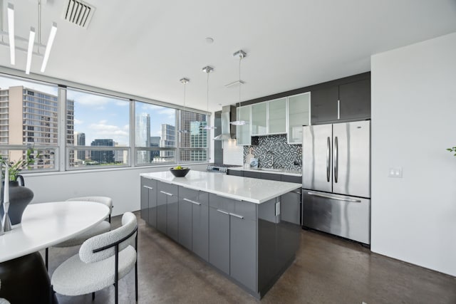 511 N Akard St Unit 1501, Dallas, TX 75201 - kitchen with stainless steel appliances, finished concrete flooring, wall chimney range hood, and gray cabinetry