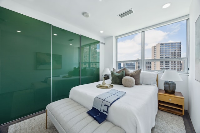 511 N Akard St Unit 1501, Dallas, TX 75201 - bedroom featuring a view of city, a closet, and recessed lighting