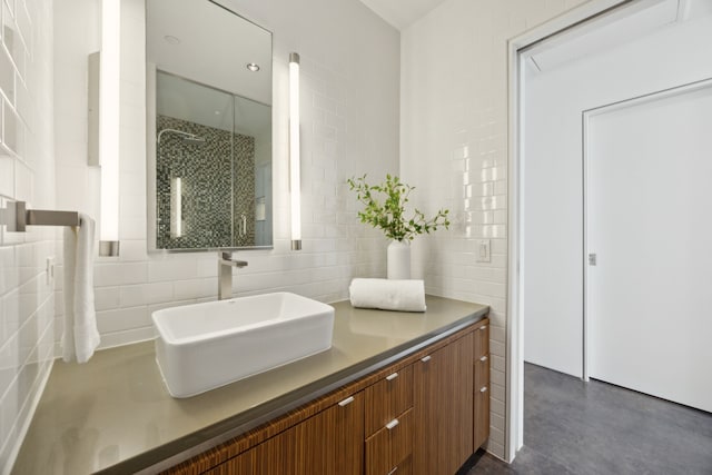 511 N Akard St Unit 1501, Dallas, TX 75201 - full bath featuring tile walls, vanity, tiled shower, concrete floors, and tasteful backsplash