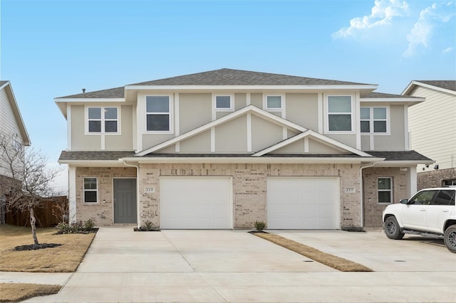 219 Griffith Dr, Princeton, TX 75407 - townhome / multi-family property with driveway, an attached garage, roof with shingles, stucco siding, and brick siding