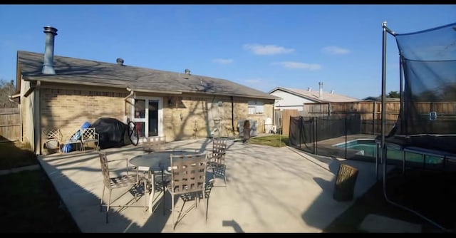 10125 Peppertree Ln, Fort Worth, TX 76108 - fenced backyard featuring a patio, a grill, and outdoor dining area