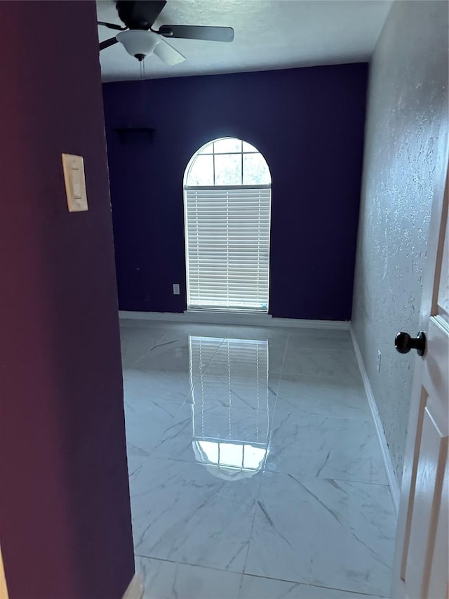 10125 Peppertree Ln, Fort Worth, TX 76108 - spare room featuring ceiling fan, baseboards, and marble finish flooring