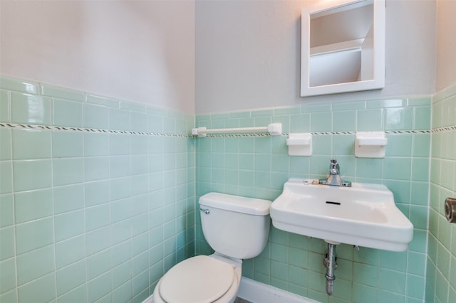 2018 Shawnee St, Denton, TX 76209 - bathroom with toilet, tile walls, and wainscoting