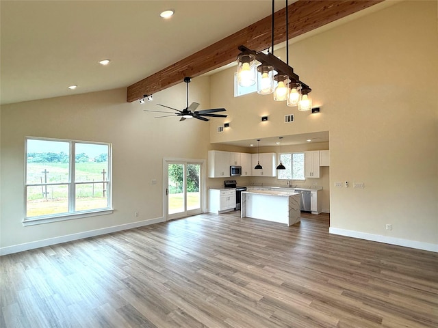 5517 Stonegate Cir, Granbury, TX 76048 - unfurnished living room featuring high vaulted ceiling, baseboards, ceiling fan, plenty of natural light, and beamed ceiling
