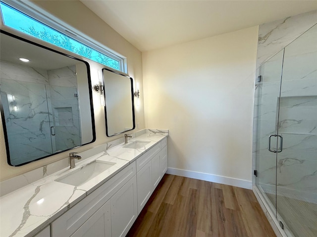 5517 Stonegate Cir, Granbury, TX 76048 - bathroom featuring wood finished floors, baseboards, a marble finish shower, and double vanity