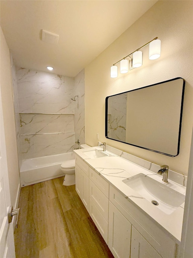 5517 Stonegate Cir, Granbury, TX 76048 - full bathroom featuring toilet, wood finished floors, shower / bathtub combination, double vanity, and recessed lighting