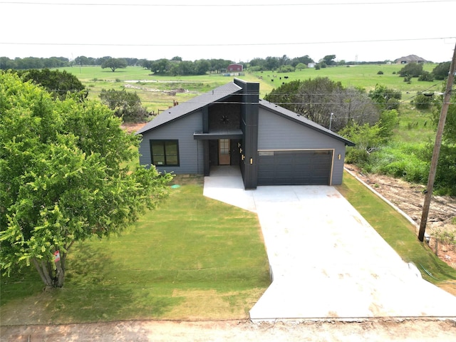 5517 Stonegate Cir, Granbury, TX 76048 - view of front of house with a view of countryside, driveway, an attached garage, and a front yard