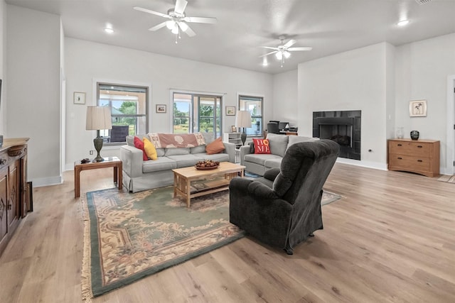 1461 Vz County Road 4607, Ben Wheeler, TX 75754 - living room with a ceiling fan, light wood-type flooring, a tile fireplace, and recessed lighting