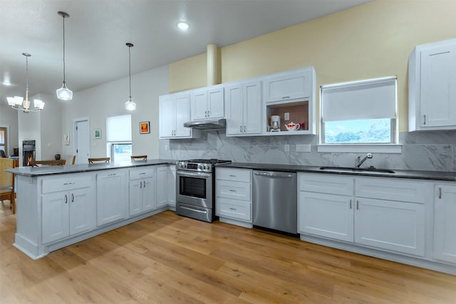 1461 Vz County Road 4607, Ben Wheeler, TX 75754 - kitchen featuring appliances with stainless steel finishes, a sink, dark countertops, a peninsula, and under cabinet range hood