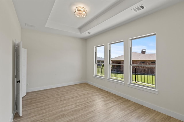 3725 Creek View Dr, Mckinney, TX 75071 - empty room with light wood-style floors, baseboards, and a raised ceiling