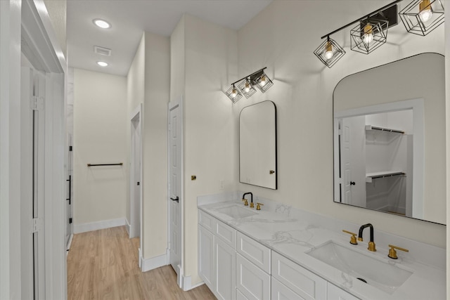 3725 Creek View Dr, Mckinney, TX 75071 - full bathroom featuring double vanity, wood finished floors, a spacious closet, recessed lighting, and baseboards