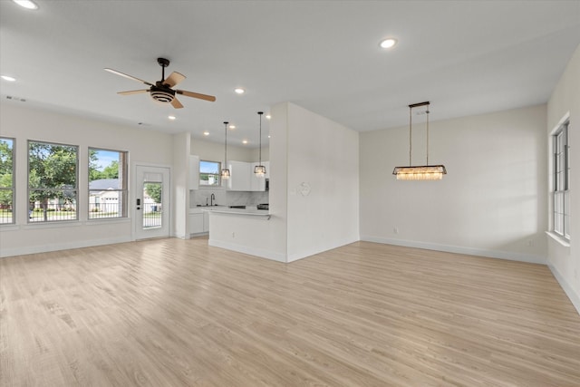 3725 Creek View Dr, Mckinney, TX 75071 - unfurnished living room with a sink, light wood-style floors, baseboards, a ceiling fan, and recessed lighting
