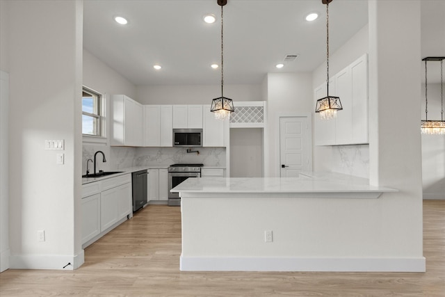 3725 Creek View Dr, Mckinney, TX 75071 - kitchen with appliances with stainless steel finishes, a sink, a peninsula, white cabinets, and light wood-style flooring