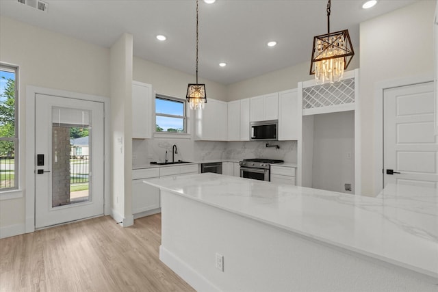 3725 Creek View Dr, Mckinney, TX 75071 - kitchen with a chandelier, stainless steel appliances, light stone counters, white cabinetry, and recessed lighting